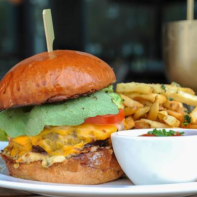 Cheeseburger and fries, with sauce on the side