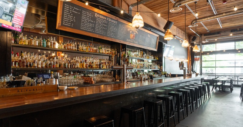 Bar, stools, drink rack behind