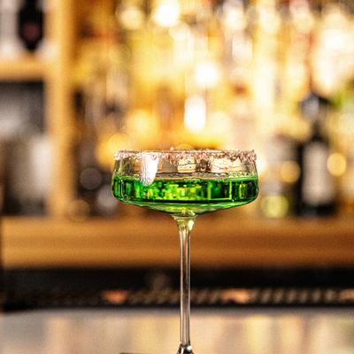 Appletini served in rimmed coupe glass.