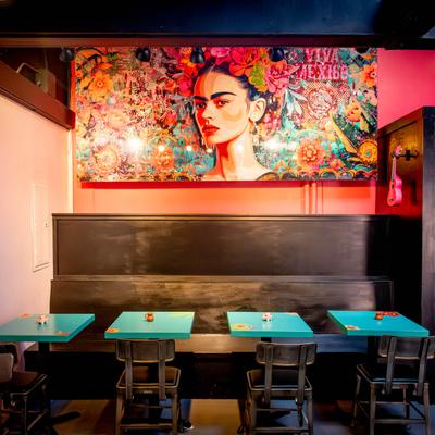 Interior seating area with chairs and a booth, traditional decoration.