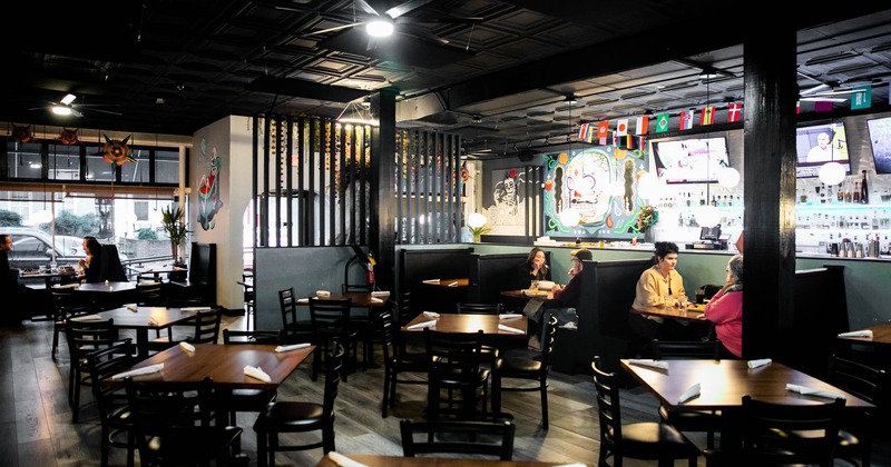 Interior, dining tables and booths, and a bar