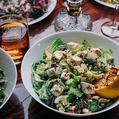 Salad with lettuce, arugula, asparagus, marinated feta, olives, radish, and bagel crunch.
