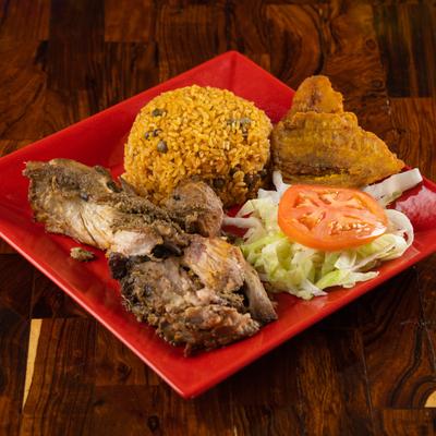 Cooked pork, with salad and rice.