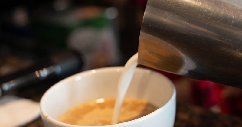 Pouring milk in the coffee