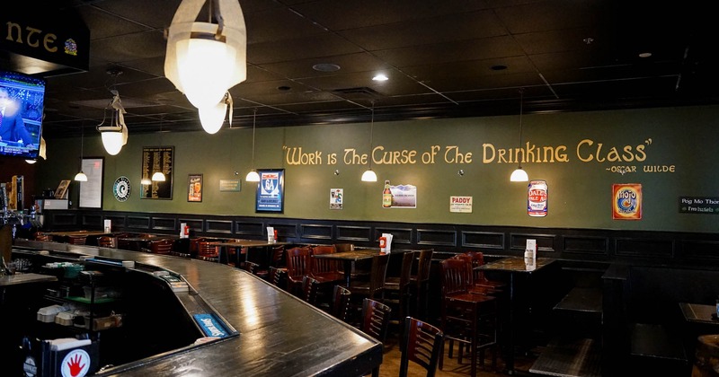 Bar area with tables and chairs in the back