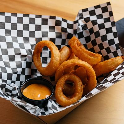 Whiskey battered onion rings served with Vintage Hangout fry sauce.