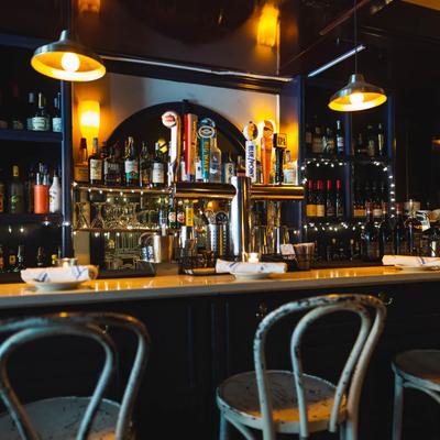 Interior, bar, chairs in front and drink rack behind