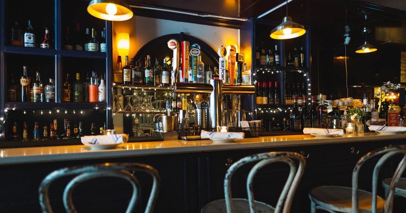 Interior, bar, chairs in front and drink rack behind