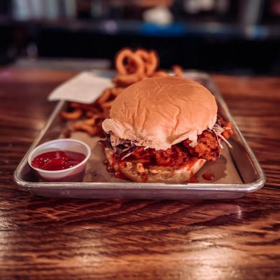 Hot chicken sandwich, with slaw and onion rings.