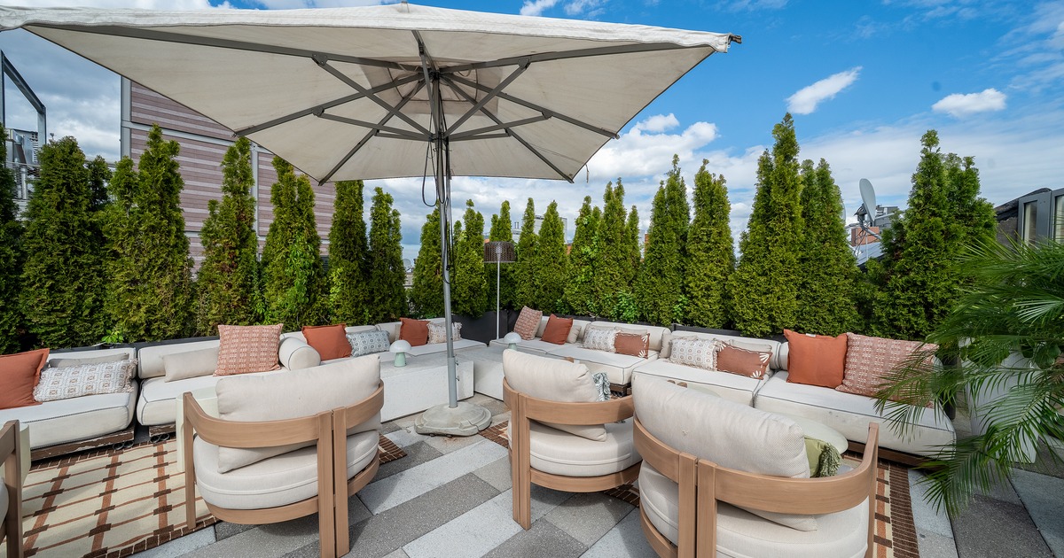 Modern rooftop lounge and outdoor seating area with an upscale design