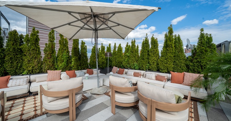 Modern rooftop lounge and outdoor seating area with an upscale design