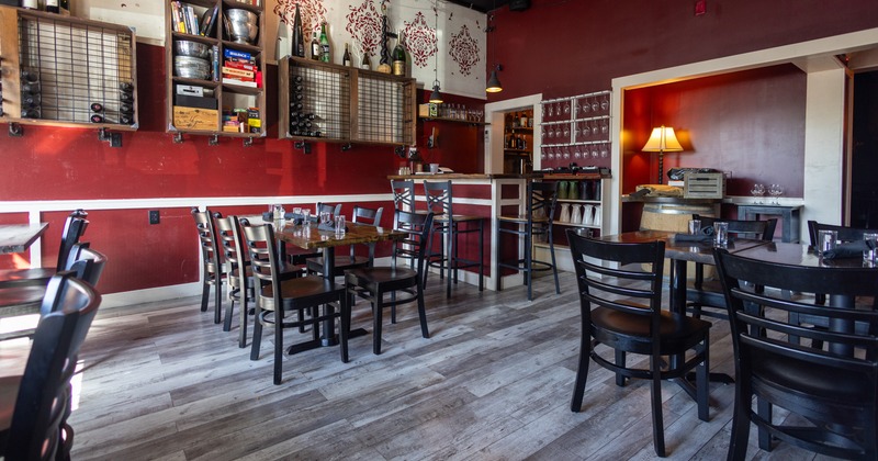 Interior, diner room, tables, chairs,  wine racks on the wall, wine bar in the corner