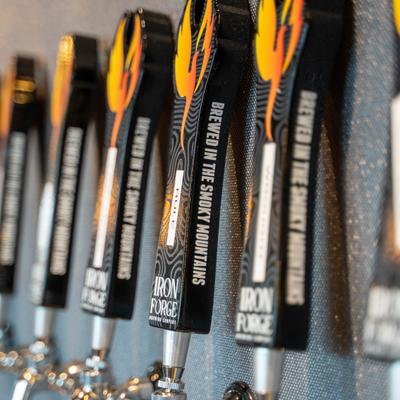 Custom beer tap handles designed with a black and orange color scheme.