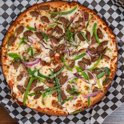 Pizza with red sauce, sausage, peppers, onion, garlic, basil, provolone, and parmesan.