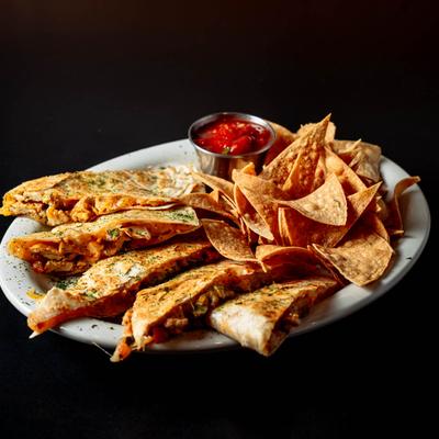 Chicken quesadillas, served with tortilla chips, and salsa.