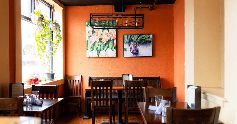 Interior, tables, chairs, and paintings on the wall