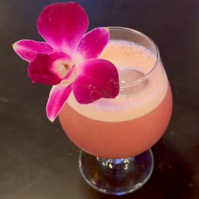 I Don't Know Yet cocktail garnished with an orchid flower.