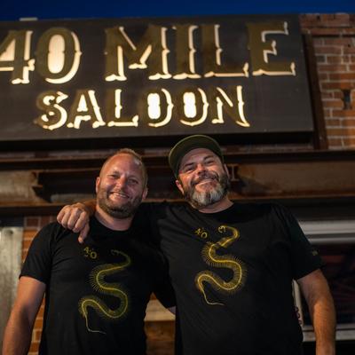 Two people posing outside of the venue.