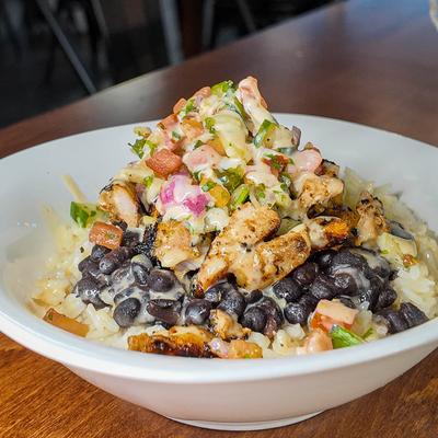 Chicken rice bowl with black beans and fresh pico de gallo.