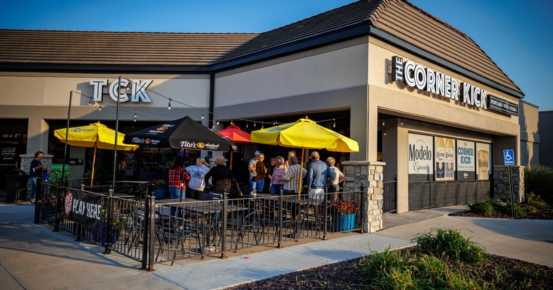 Exterior, angle view to restaurant, patio in front, tables , chairs, parasols