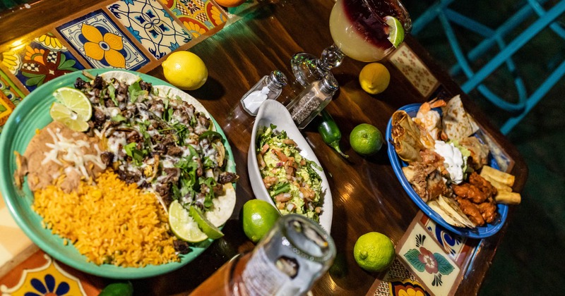 Various types of cocktails and dishes on the table, top angle view