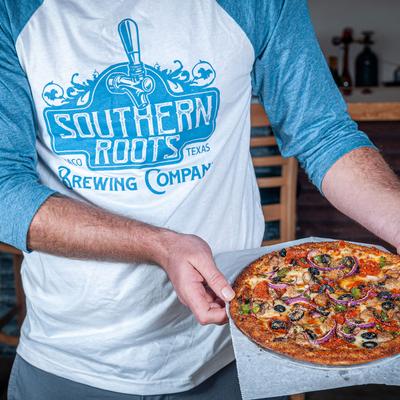 Staff member serving pizza