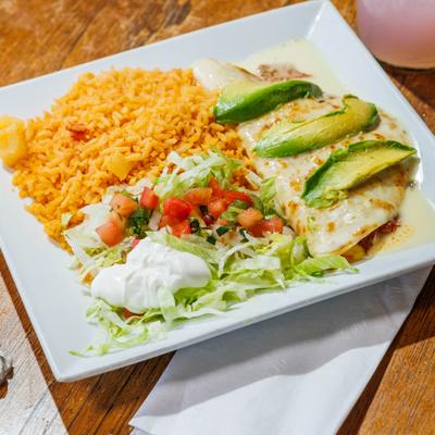 Quesadilla Jalisco served with sides of rice, sour creme, lettuce and pico de gallo.