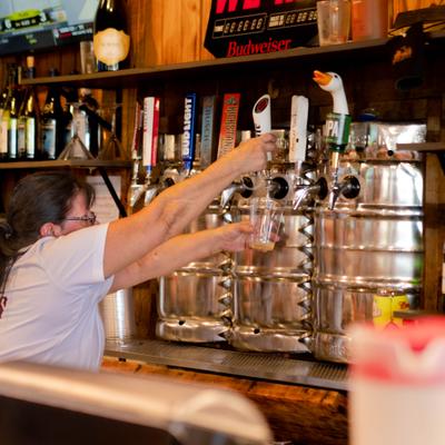 A person pouring beer.