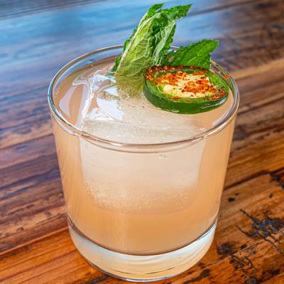 Blushing and Blazing cocktail with mint and jalapeno garnish