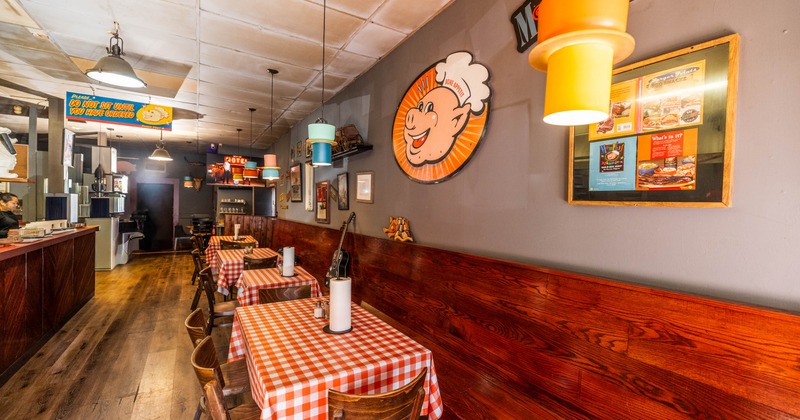 Interior of a casual restaurant with checkered tablecloths and retro decorations