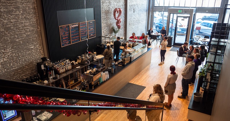 Interior, coffee and food counter, waiting line for pick up, view from gallery