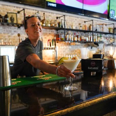 Bartender serving drinks.