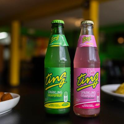 Two bottles of different grapefruit sodas served on the table.
