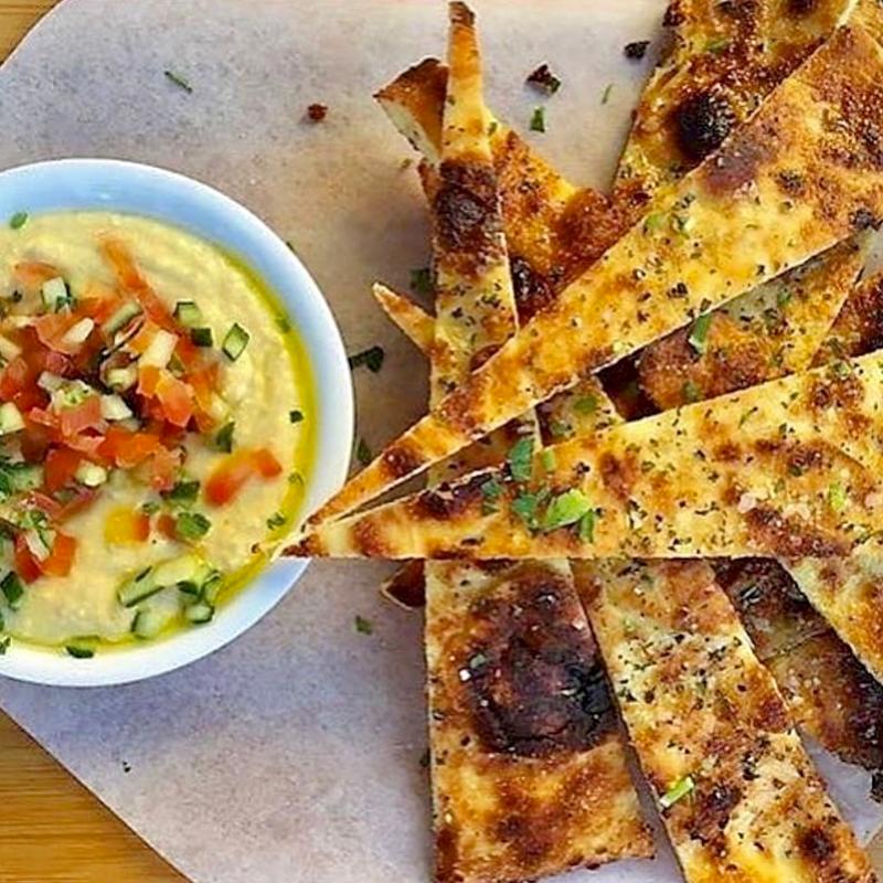 House made jalapeño hummus topped with cucumber and tomato, our flatbread - can be GF photo