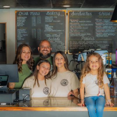 Staff posing together behind the counter.