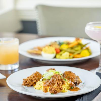 Crispy Fried Chicken Livers, cocktails and a food plate in the background