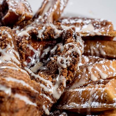 Sweet potato waffles and crispy fried chicken wings, close-up.