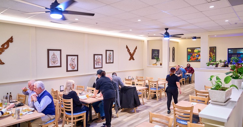 Interior, dining area, guests sitting and enjoying their food and drinks