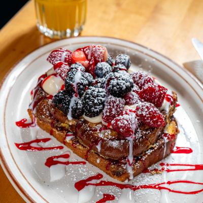 Berry topped french toast with powdered sugar.