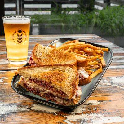 Grilled sandwich with fries and a pint of beer.