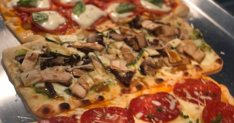 A variety of flatbread pizzas, each with different toppings