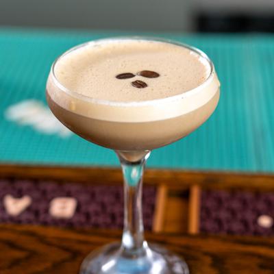 Espresso Martini served in a coupe, garnished with coffee beans.