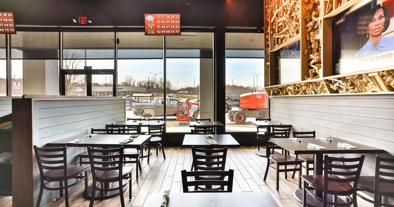 Interior, bright seating area with tables and chairs