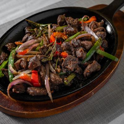 Tender beef sauteed with rosemary, onion, and green peppers.