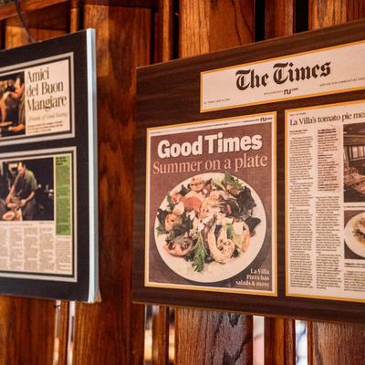 Framed newspaper articles on a wall.