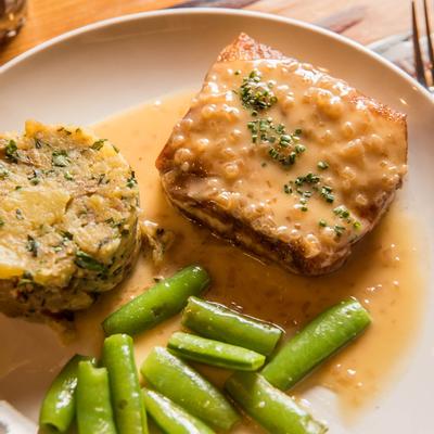 Pan-seared halibut with sauce, green beans and crab cake
