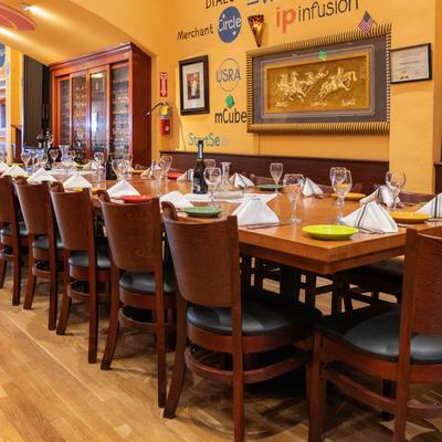 Restaurant interior, a long table set for dining.
