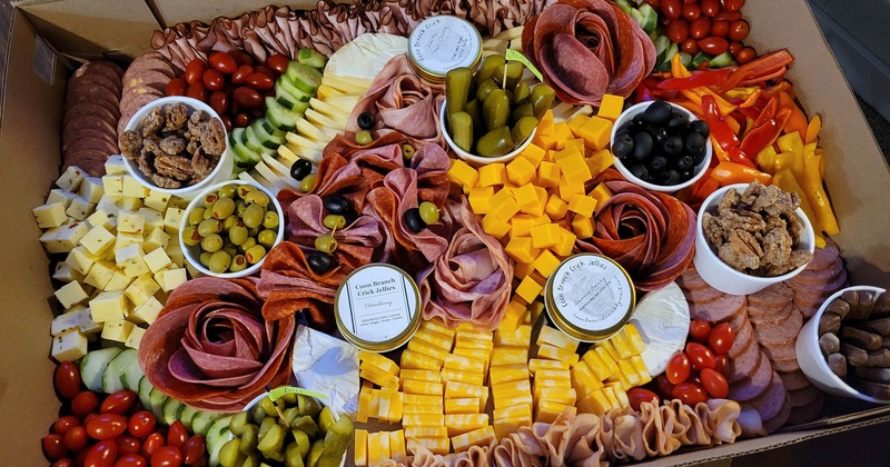 A large sampler board with numerous foods