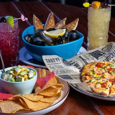 Appetizers including ceviche, mussels, and lobster flatbread.