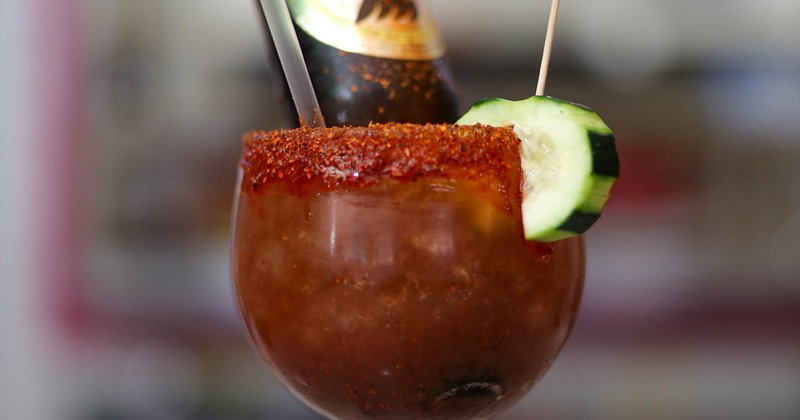 Cocktail garnished with cucamber, closeup